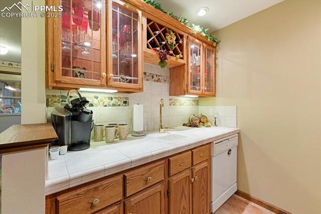 18145 Furrow Road Monument, CO 80132 - Photo 15 of 30 The lower level wet bar has everything you need for movie night!
