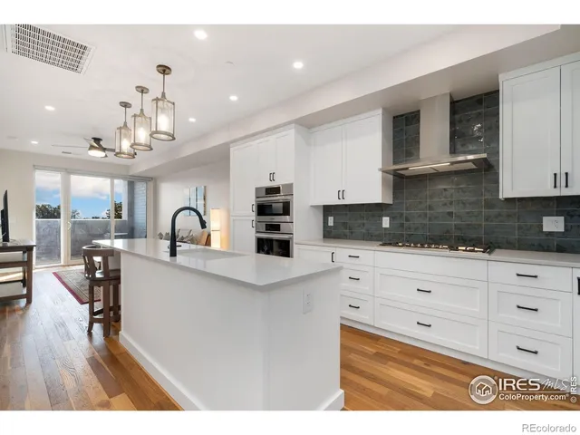 a kitchen with a refrigerator and a sink