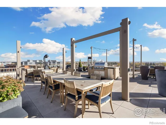 a patio with a table and chairs