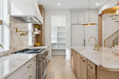 a kitchen with stainless steel appliances granite countertop a sink stove and cabinets