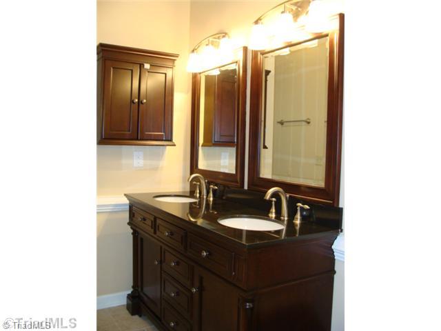 6865 High Rock Road Browns Summit, NC 27214 - Photo 12 of 16 Master Bath/Spa. Nice master bathroom with new elegant double vanity with solid surface counter top, new ceramic tiled flooring and nice lighting!