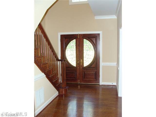 6865 High Rock Road Browns Summit, NC 27214 - Photo 3 of 16 Entry. Nice foyer with double door entry, hardwood flooring and beautiful wood rails for the staircase!