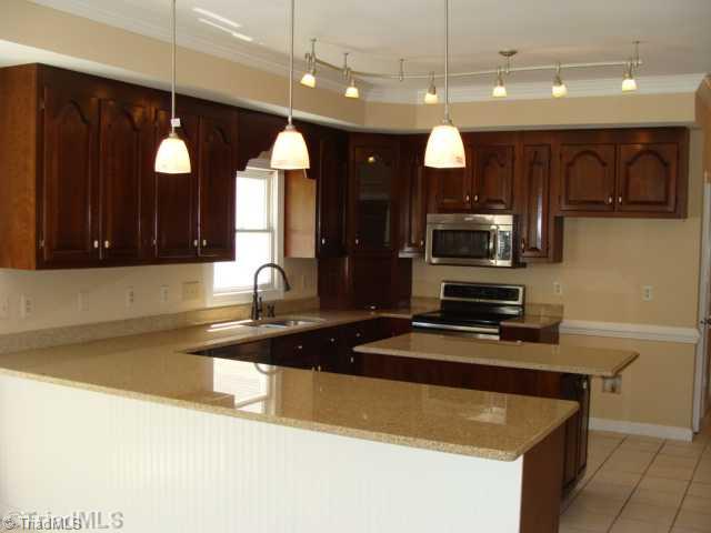 6865 High Rock Road Browns Summit, NC 27214 - Photo 5 of 16 Kitchen. Large beautiful kitchen with new granite counter counter tops & backsplash, deep stainless sink and new stainless appliances! Kitchen includes a incredible amount of cabinet/counter top space! Also includes ceramic tiled flooring and new lighting!
