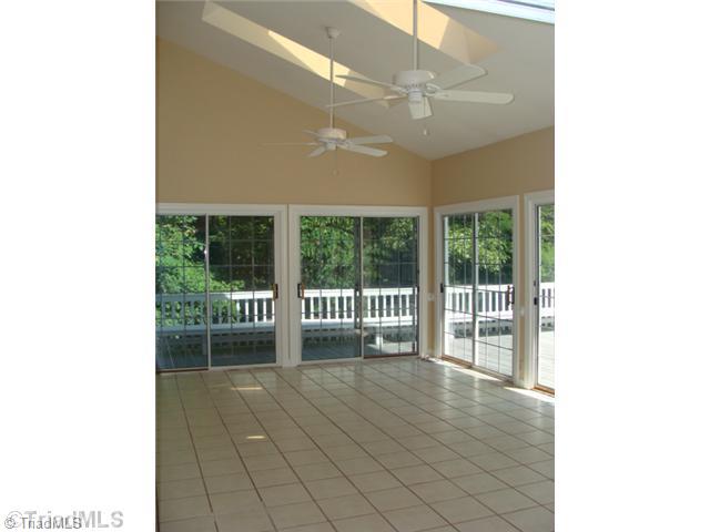 6865 High Rock Road Browns Summit, NC 27214 - Photo 9 of 16 Sunroom. Large heated and cooled sun room! Nice tiled flooring, ceiling fans and skylights!