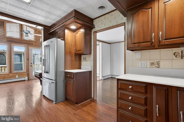 a kitchen with stainless steel appliances granite countertop a refrigerator and a stove top oven