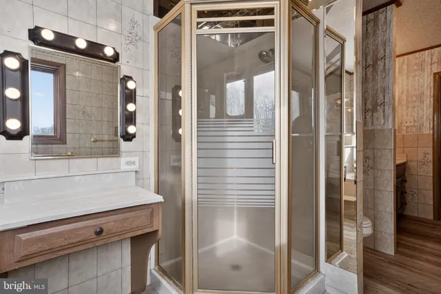 a bathroom with a shower and a sink