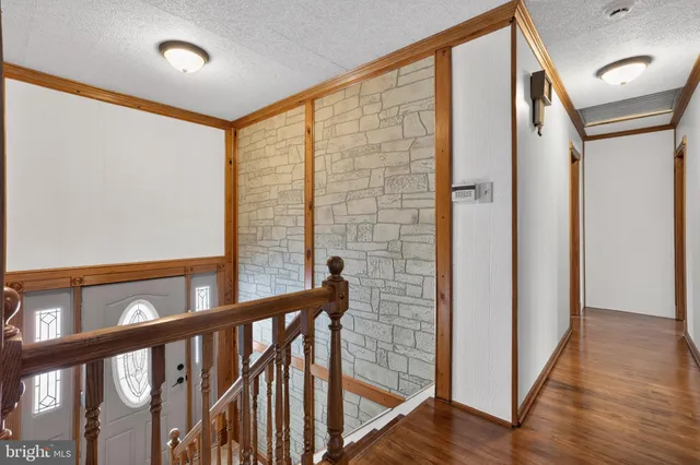 a view of an entryway with wooden floor