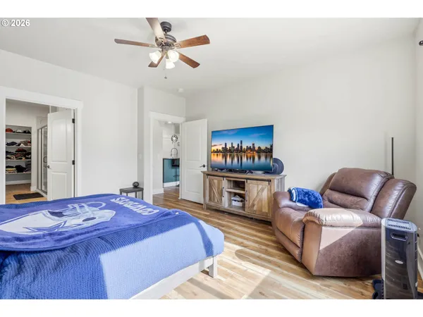 a living room with furniture a flat screen tv and a table