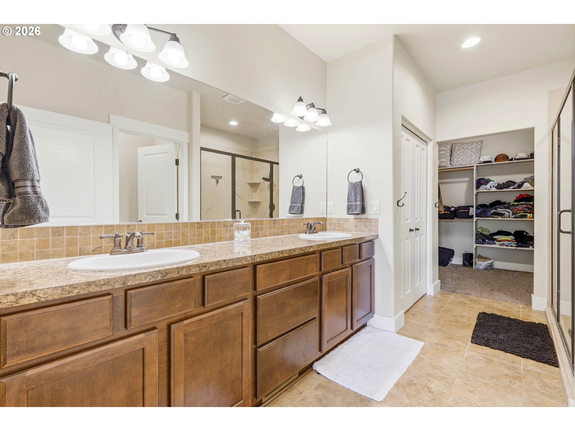 1003 Southwest Olive Court Hermiston, OR 97838 - Photo 14 of 34 a spacious bathroom with a double vanity sink a mirror and a shower