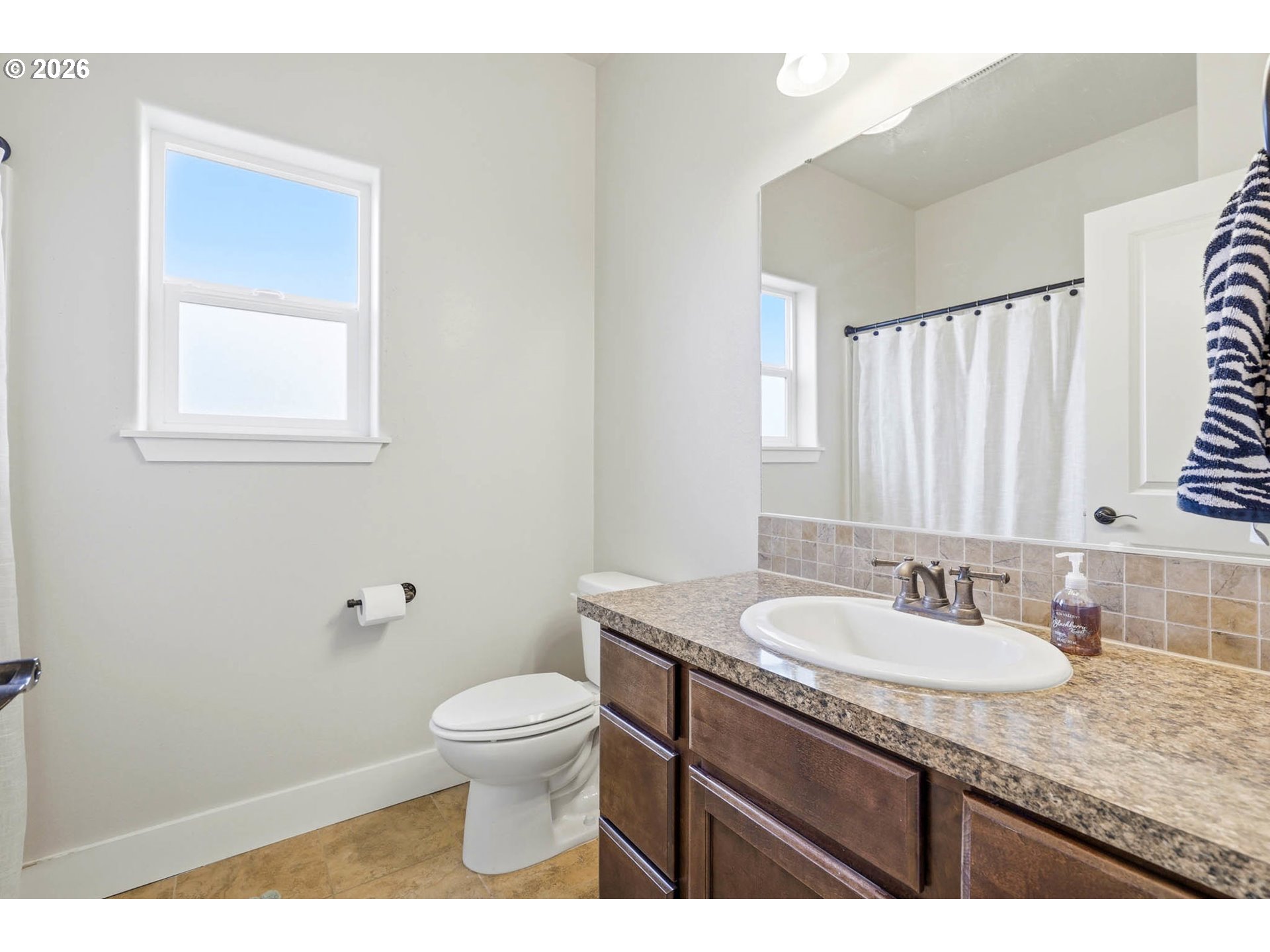 1003 Southwest Olive Court Hermiston, OR 97838 - Photo 21 of 34 a bathroom with a granite countertop sink a toilet and a mirror