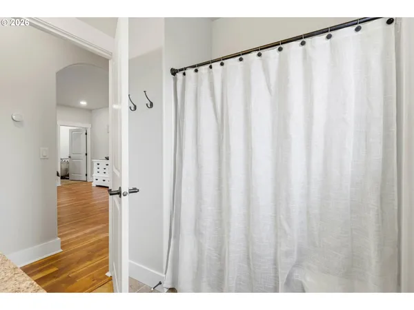 a view of a bathroom with shower curtain
