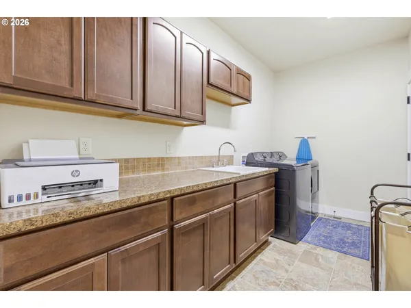a kitchen with stainless steel appliances granite countertop a sink dishwasher stove and cabinets