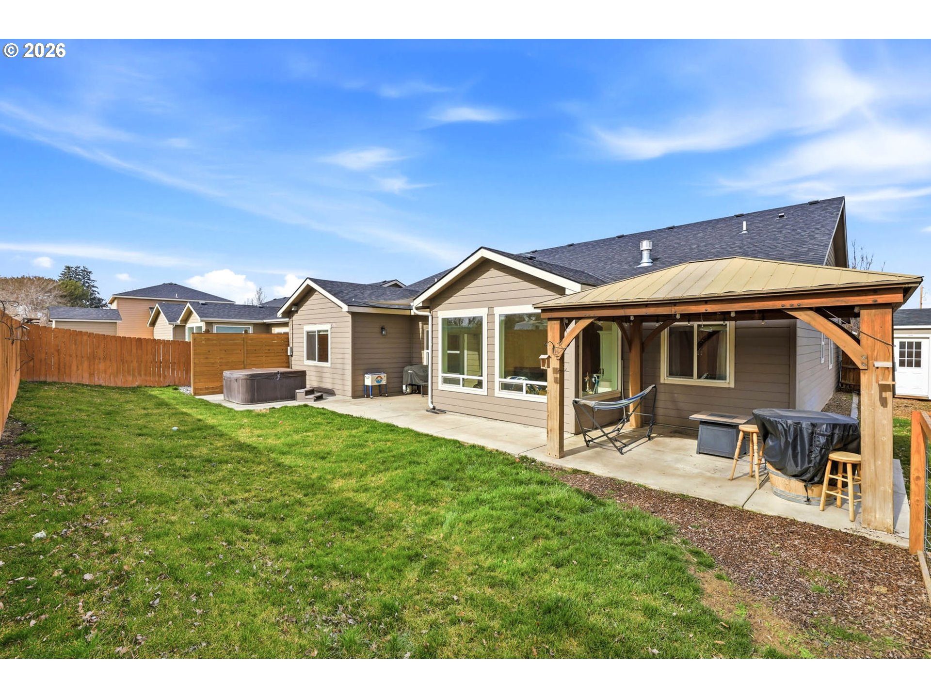 1003 Southwest Olive Court Hermiston, OR 97838 - Photo 24 of 34 a front view of a house with a garden and porch