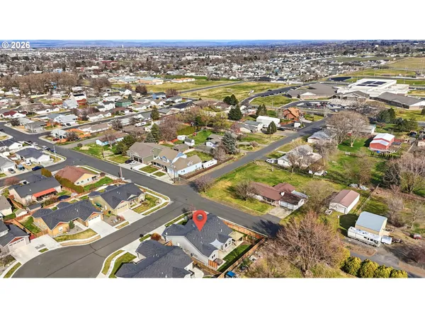 an aerial view of residential houses with outdoor space