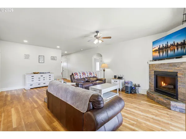 a living room with furniture a fireplace and a dining table