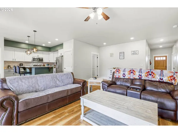 a living room with furniture and kitchen view
