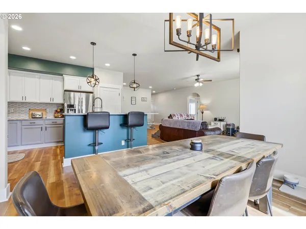 a open kitchen with stainless steel appliances kitchen island granite countertop a table and chairs