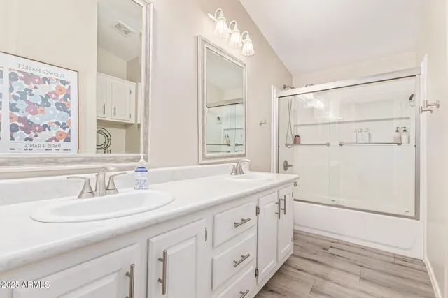 a bathroom with a sink double vanity and a mirror