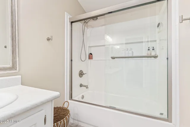 a bathroom with a shower and a sink