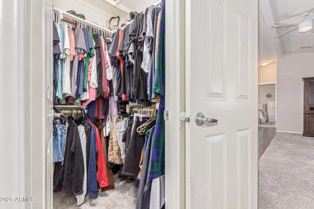 a view of walk in closet with clothes