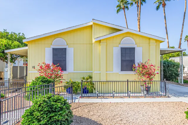 a view of a house with a small yard and plants