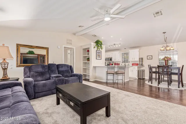 a living room with furniture a ceiling fan and a rug