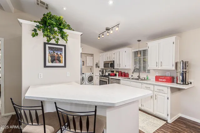 a kitchen that has a table and chairs in it