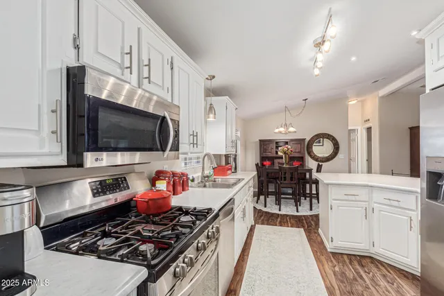 a kitchen with stainless steel appliances a stove a microwave and cabinets