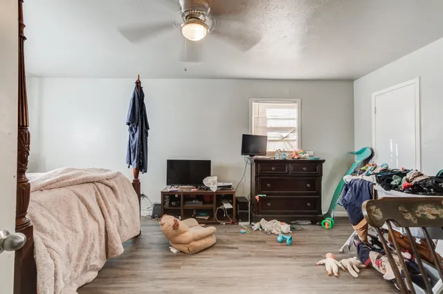 a bedroom with a bed and wooden floor