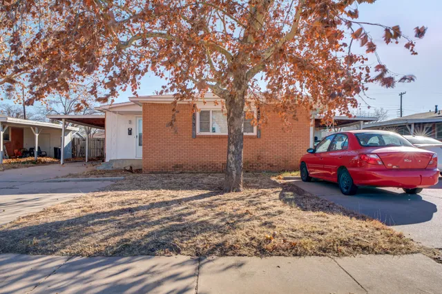 a view of a house with a cars parking space