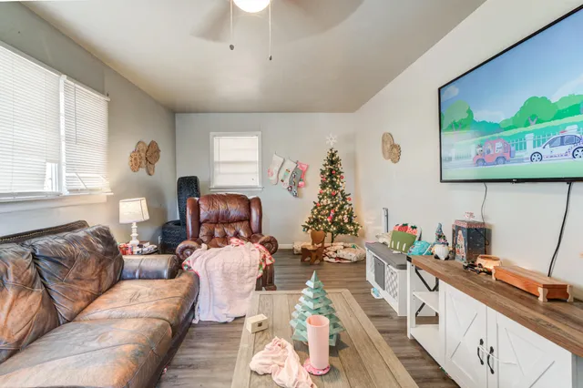 a living room with furniture and a flat screen tv
