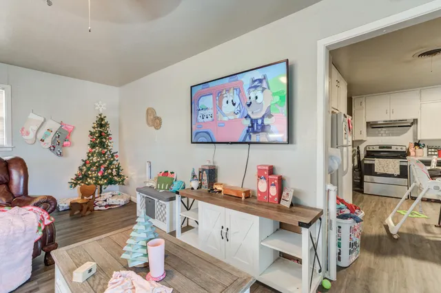 a living room with furniture and a kitchen view