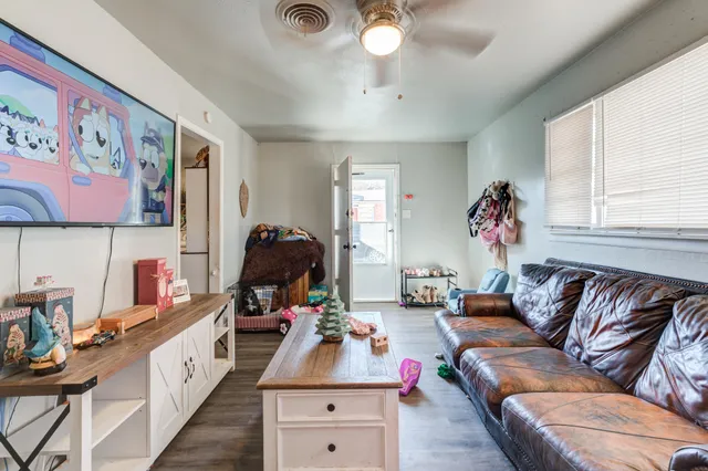 a hallway with a couch and a large window