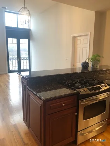 a kitchen with a stove and a wooden floor