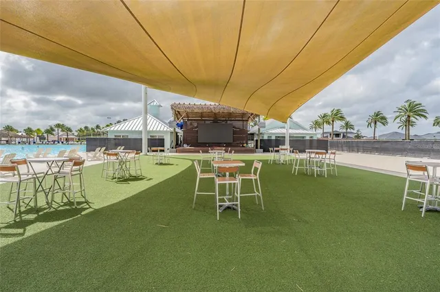 a view of a field with a big yard and a large trees