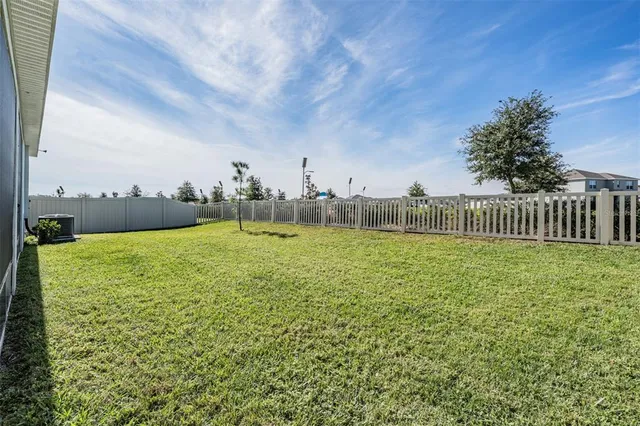 a kitchen with stainless steel appliances granite countertop a stove a sink a microwave a island with a dining table and chairs