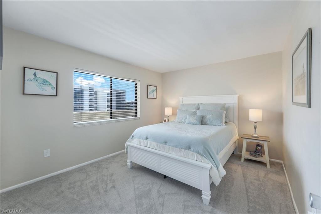 10475 Gulf Shore Drive, Unit 142 Naples, FL 34108 - Photo 12 of 14 a bedroom with a bed and a window