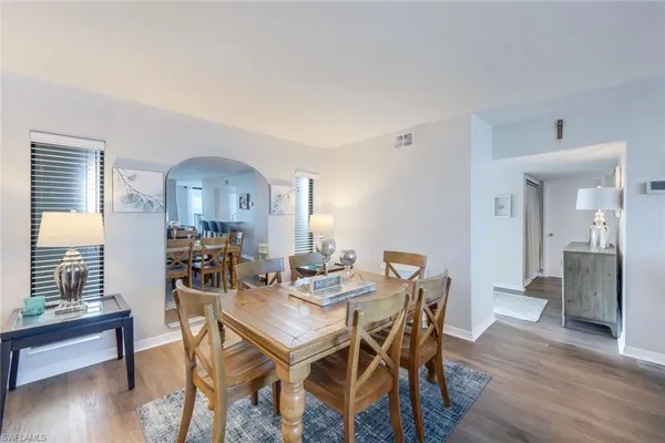 a view of a dining room with furniture and wooden floor