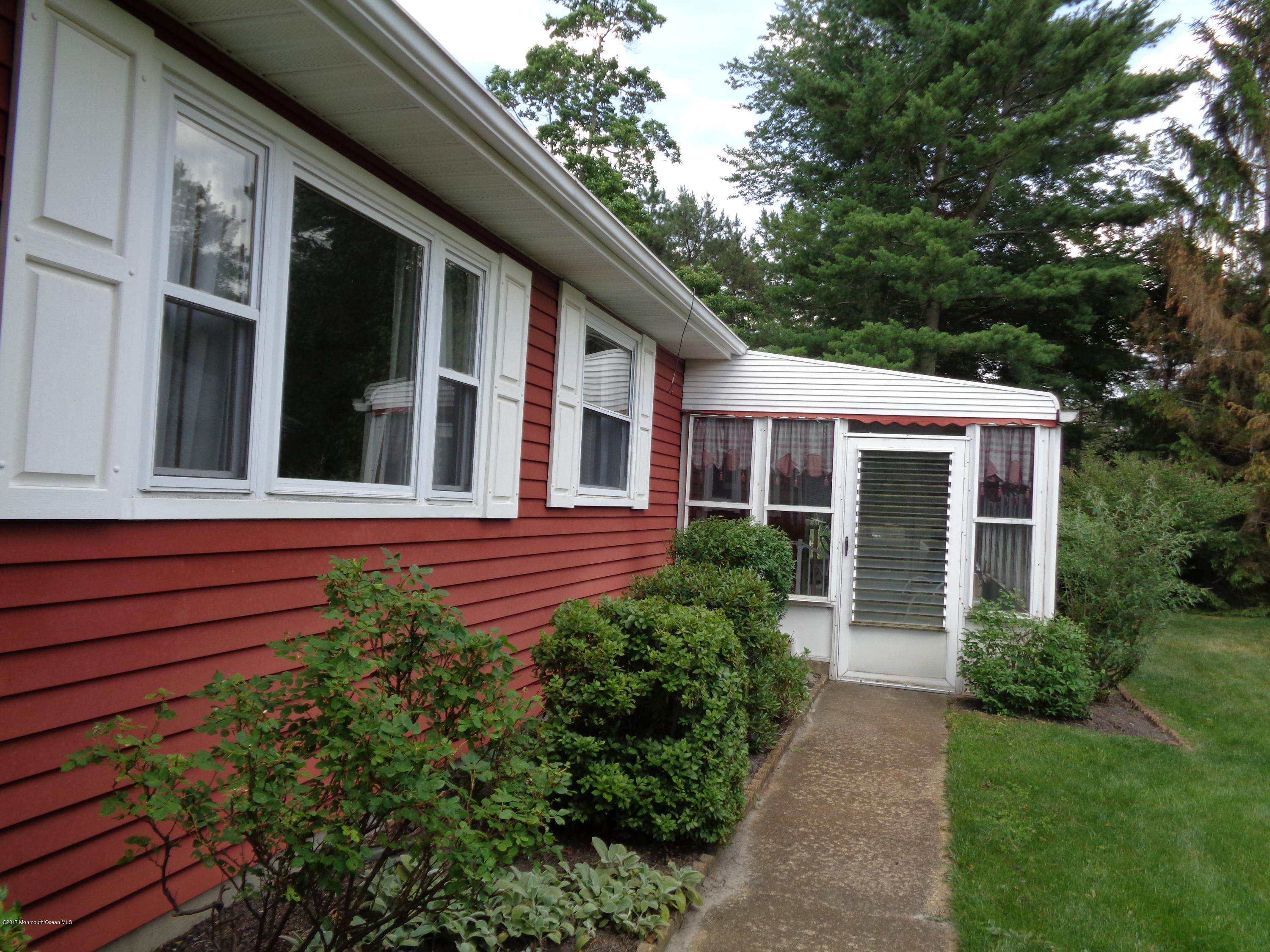 23 Ashley Road Whiting, NJ 08759 - Photo 3 of 21 a view of a house with a small yard plants and large tree