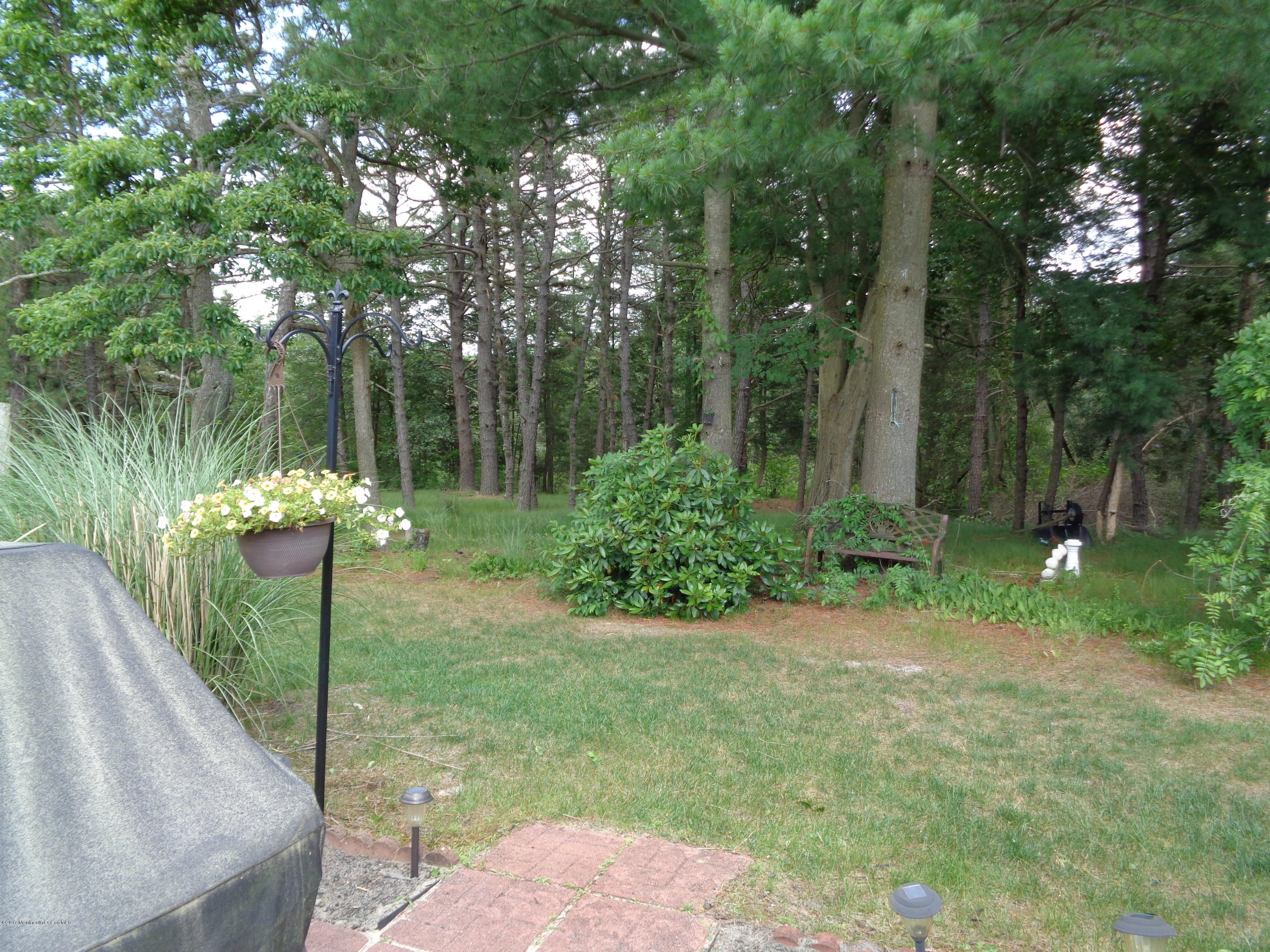 23 Ashley Road Whiting, NJ 08759 - Photo 8 of 21 a view of a garden with a fountain