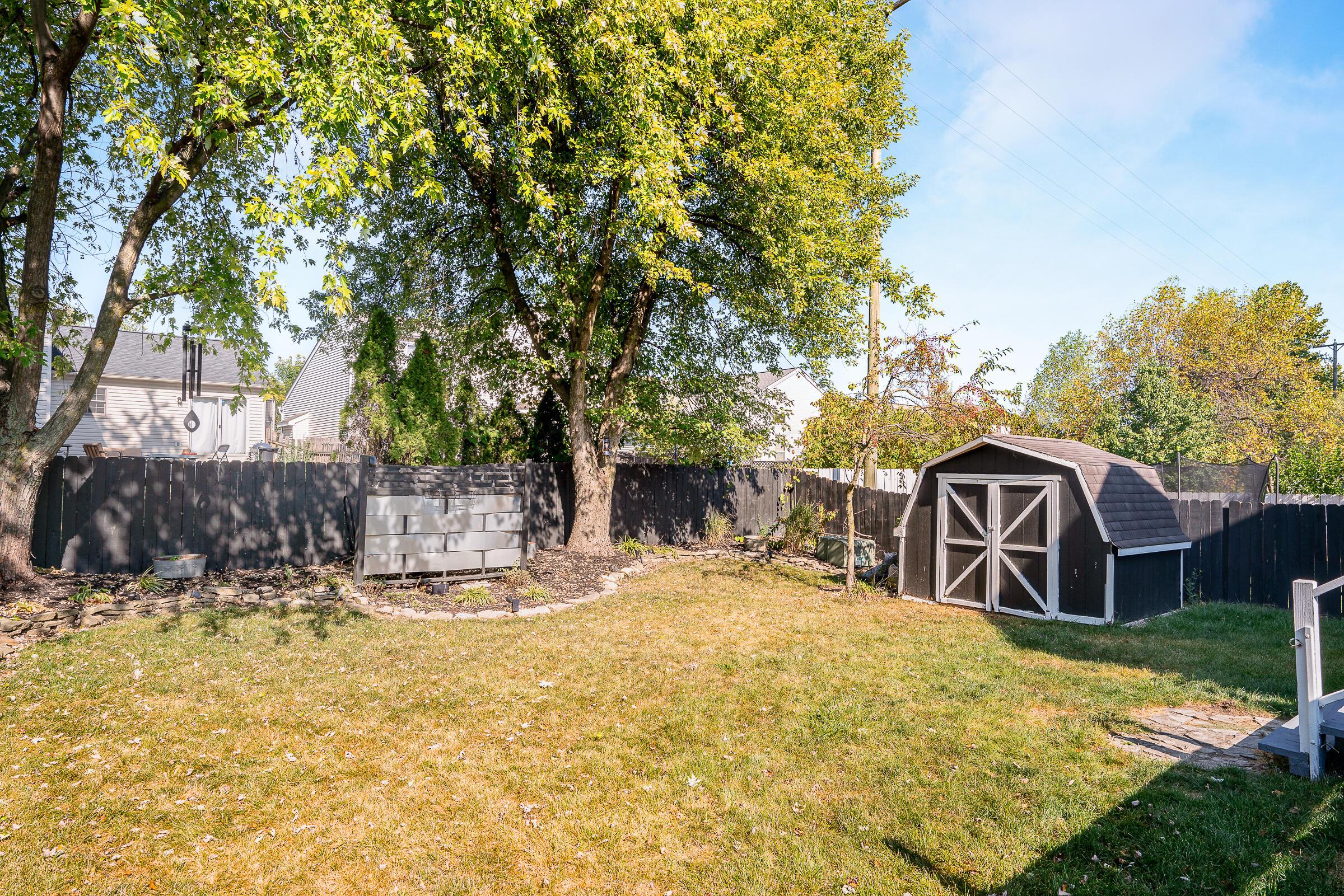 2135 Tonda Lane Grove City, OH 43123 - Photo 32 of 37 The large fenced yard features shed storage and some lovely shade trees