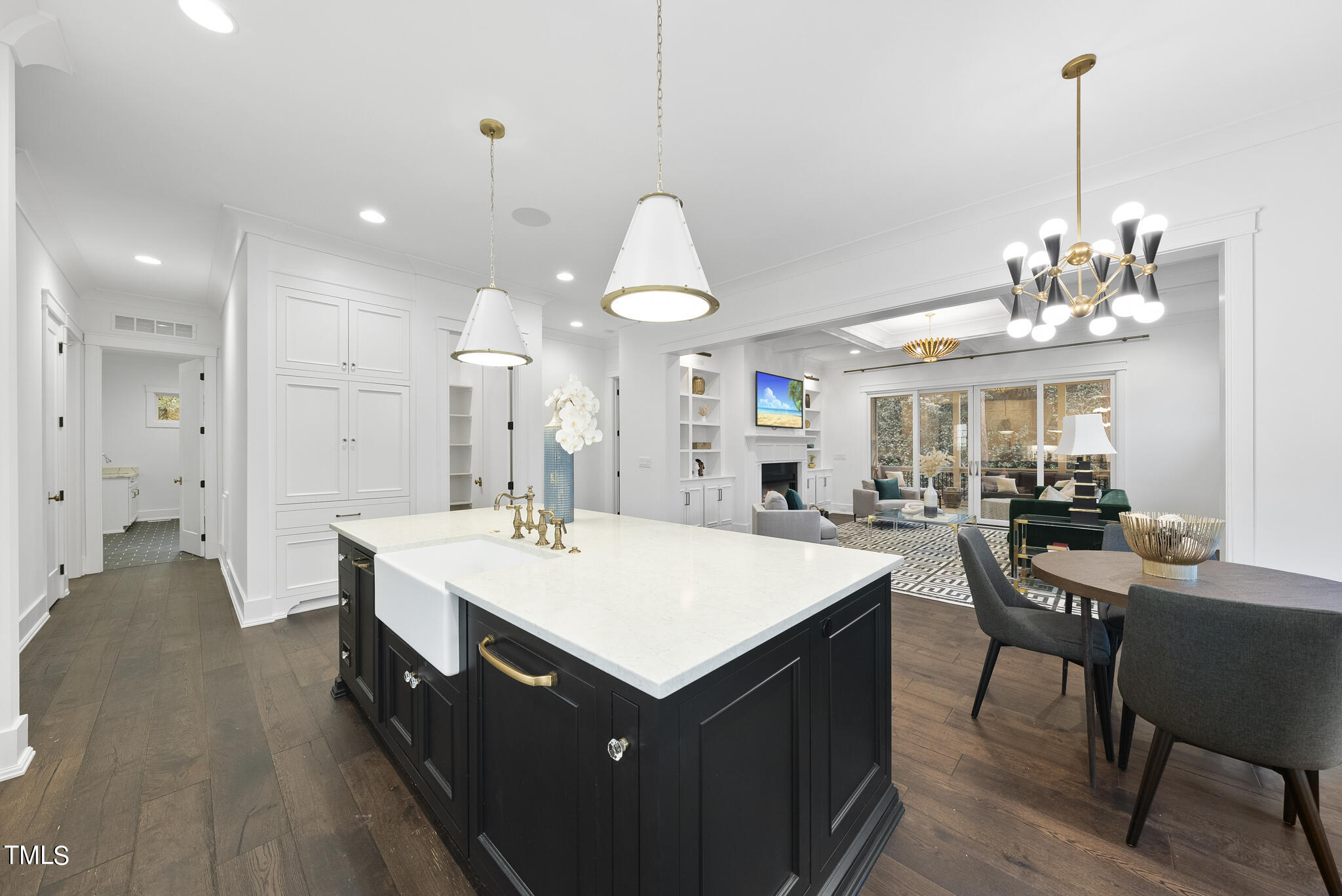 115 Edenburgh Road Raleigh, NC 27608 - Photo 15 of 50 a large white kitchen with a sink and living room view