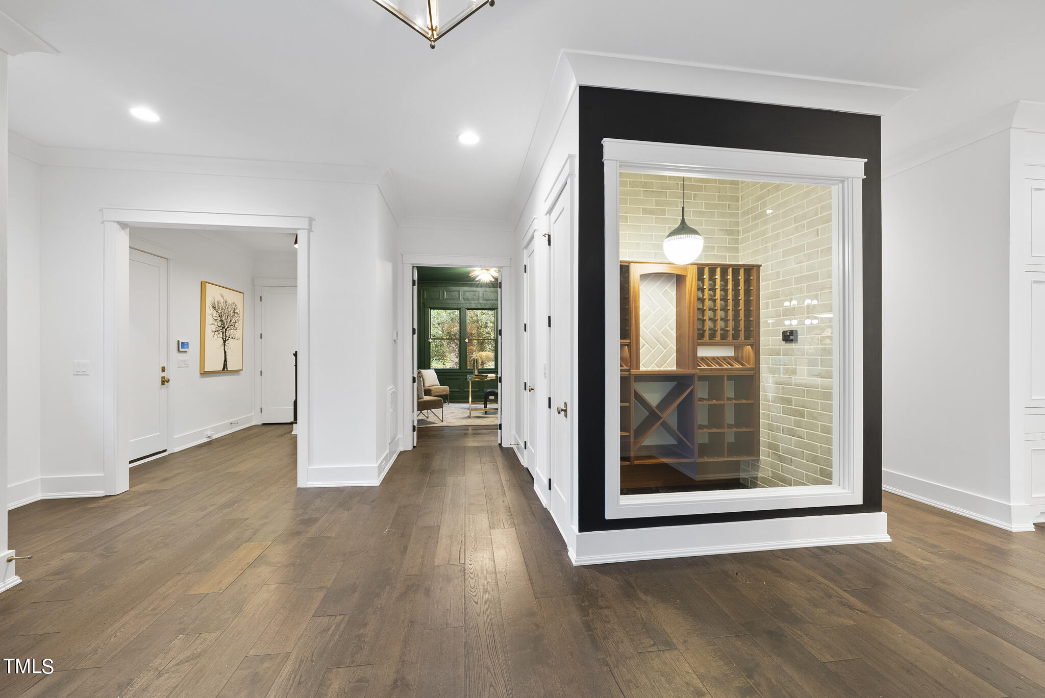 115 Edenburgh Road Raleigh, NC 27608 - Photo 4 of 50 a view of a hallway with wooden floor and a bathroom