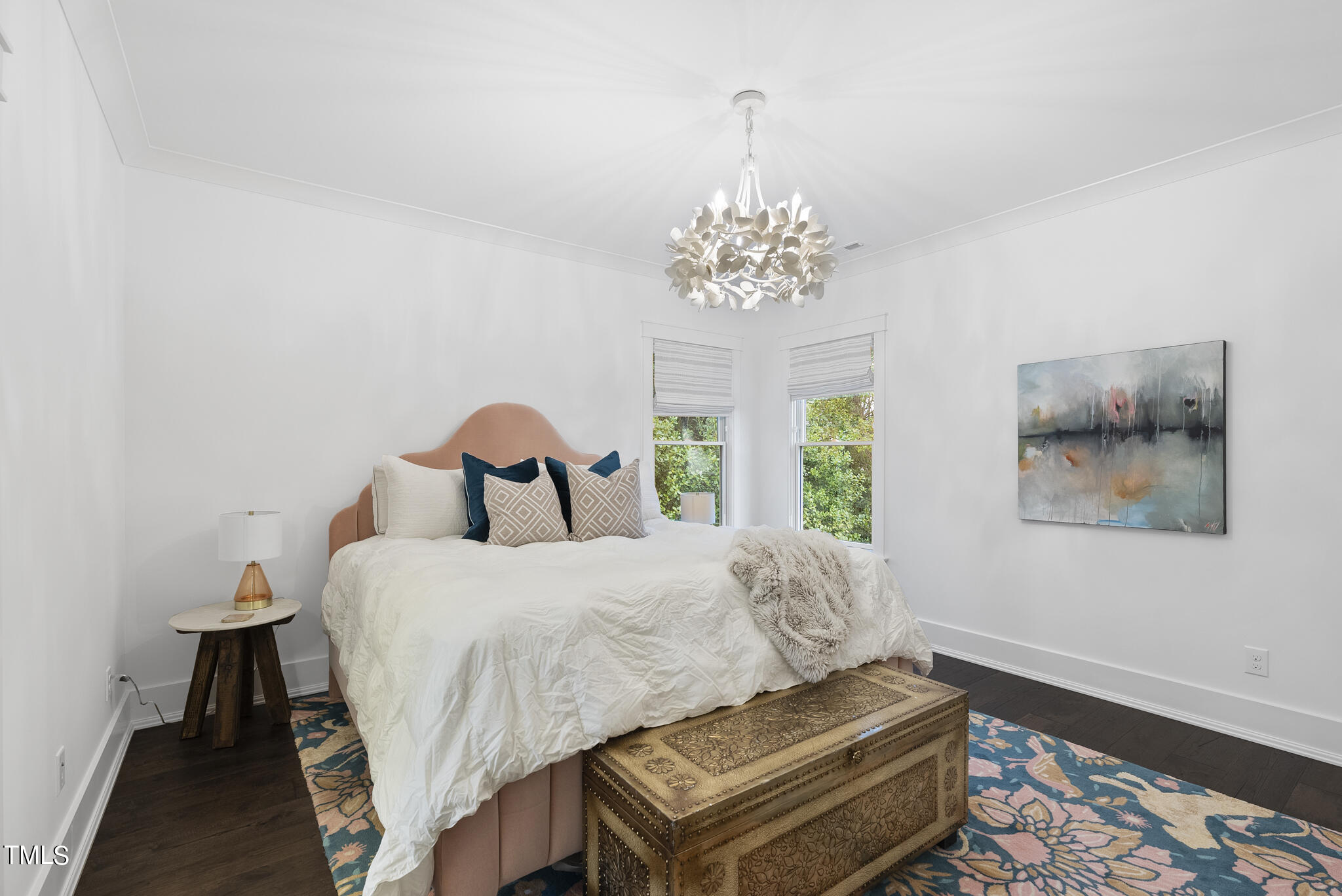 115 Edenburgh Road Raleigh, NC 27608 - Photo 41 of 50 a bedroom with a bed and a chandelier