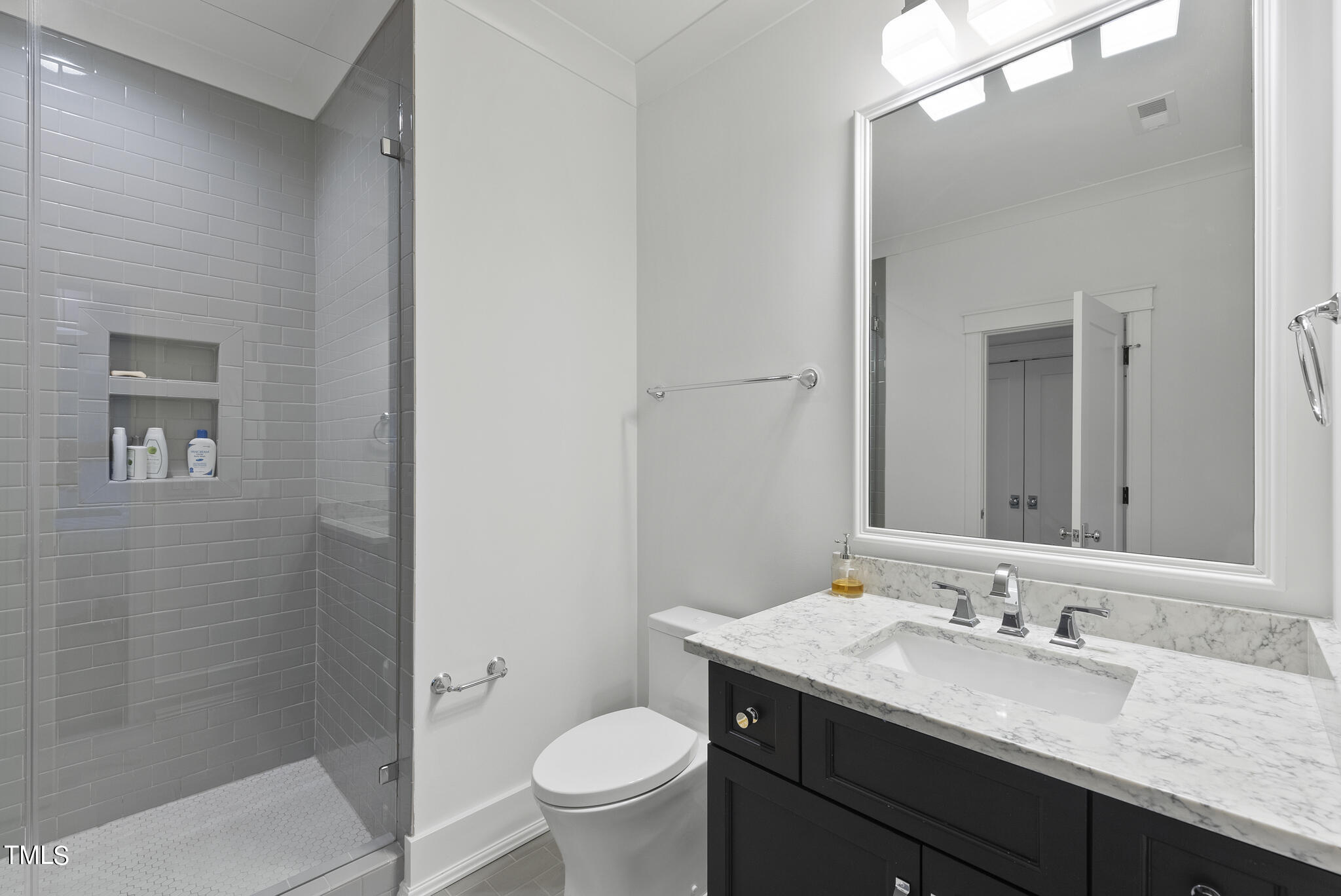 115 Edenburgh Road Raleigh, NC 27608 - Photo 45 of 50 a bathroom with a granite countertop sink a toilet and a mirror