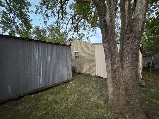 a view of a backyard with side of the house
