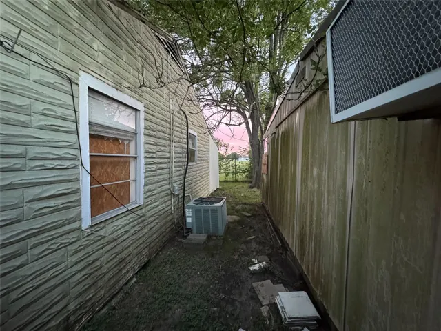 a view of a small house in middle of the forest