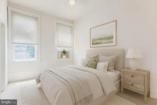 a bedroom with a bed and a painting on the wall