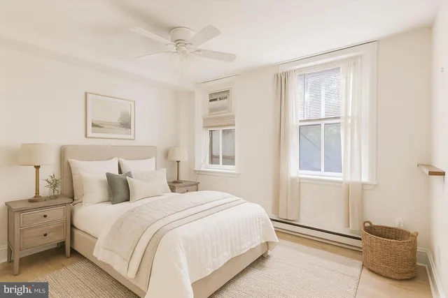 a bedroom with a large bed and a window