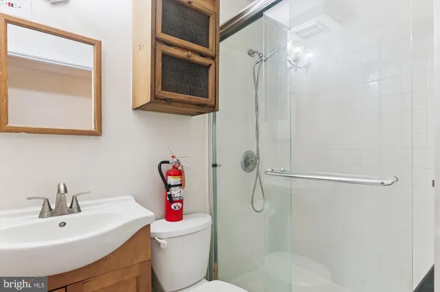 a bathroom with a sink toilet and shower